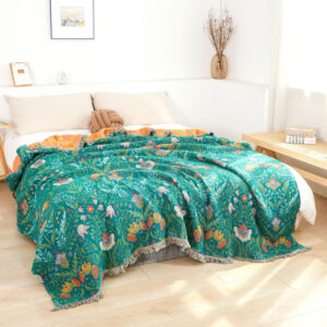 Cotton jacquard botanical garden throw blanket displayed on bed