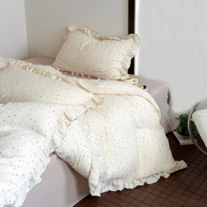 Full view of cotton muslin ruffled polka dot duvet cover set on bed