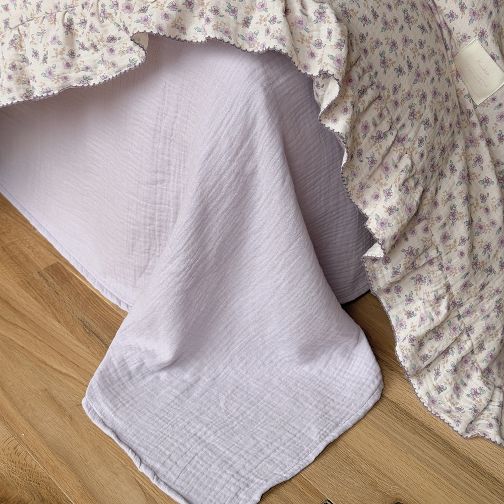 cotton muslin purple floral duvet cover with light purple flat sheet on the bed