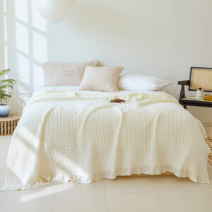 Cream cotton waffle blanket on bed