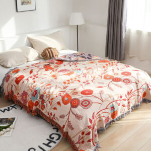 Floral Whispers throw blanket laid on bed with soft floral design