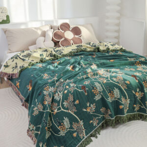 Hummingbird Garden Throw Blanket spread on bed