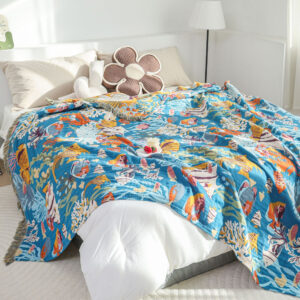 Ocean Dreams throw blanket displayed on bed with colorful sea life design
