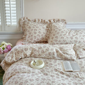 Blush rose duvet cover set with ruffled edges and soft cotton muslin fabric.