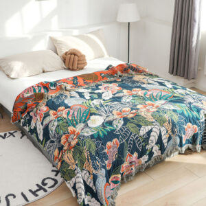 Tropical Jungle throw blanket on bed with deep blue background