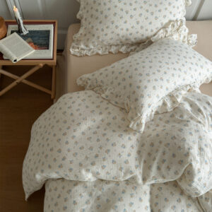 Complete vintage floral duvet cover set. Cream cotton gauze with delicate rose pattern. Includes duvet cover and matching pillowcases, ruffled edges.